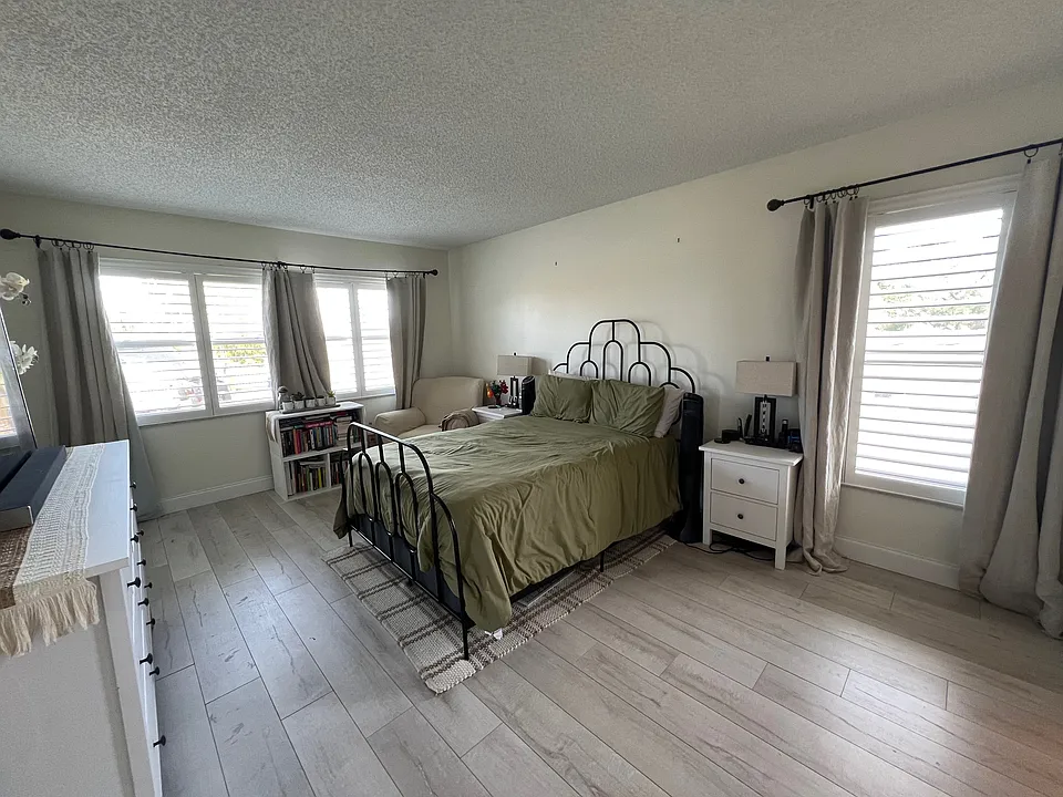 Spacious Master bedroom with plantation shutters for a dark-room sleep