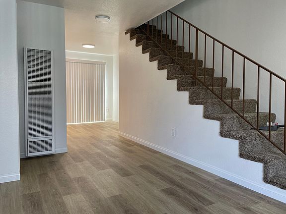 Living area facing stairwell and dining area