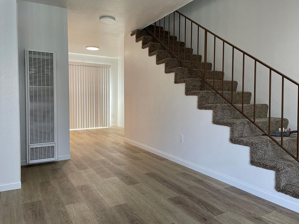 Living area facing stairwell and dining area