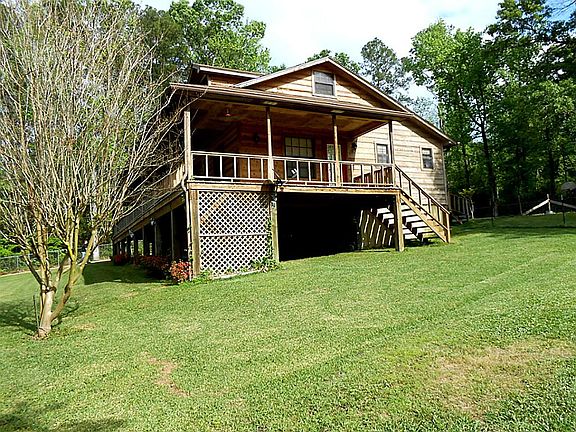 West side of main house. Open space below house could be used for storage.