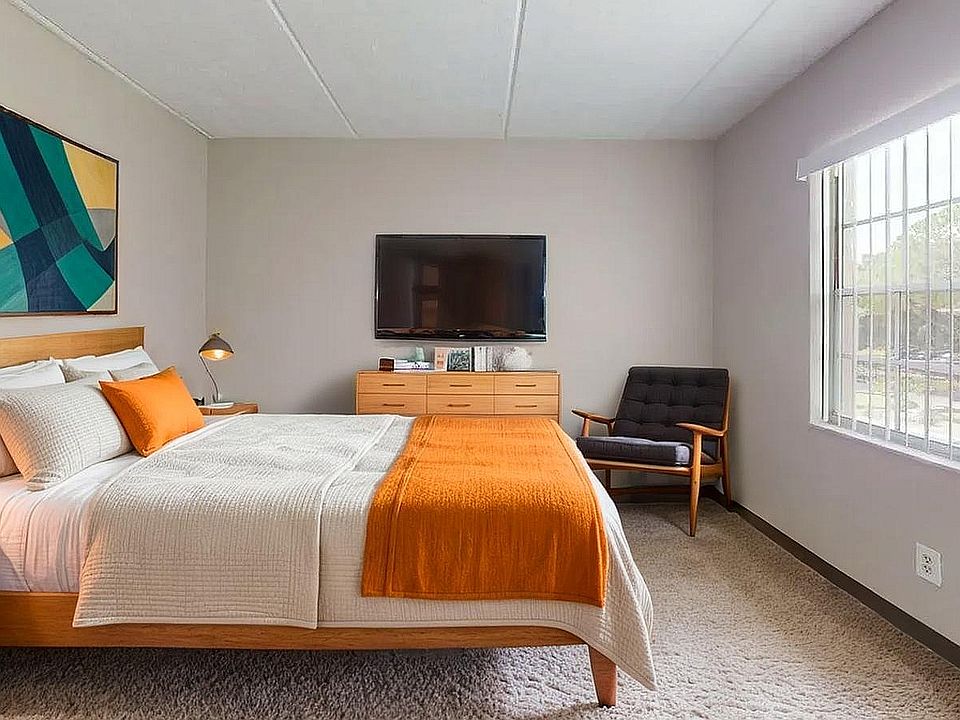 Modern bedroom with cozy double bed, vibrant decor, large window with natural light, and stylish furnishings.