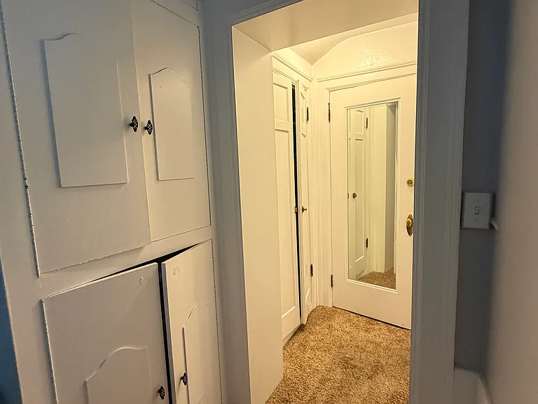 Bedroom 1 built in closet/shelves. Bathroom is through the doorway on the right.