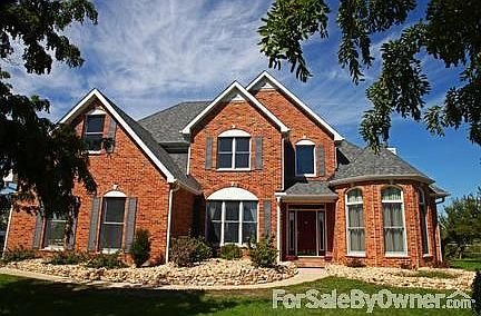 Country Estate Home
						:
						View of front of home from front landscaped area. Great appeal & grand facade!
