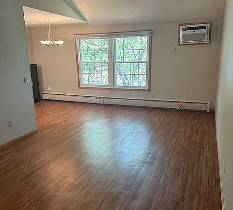 Vaulted ceiling living room with wood floors - overlooking Condo Pool and courtyard