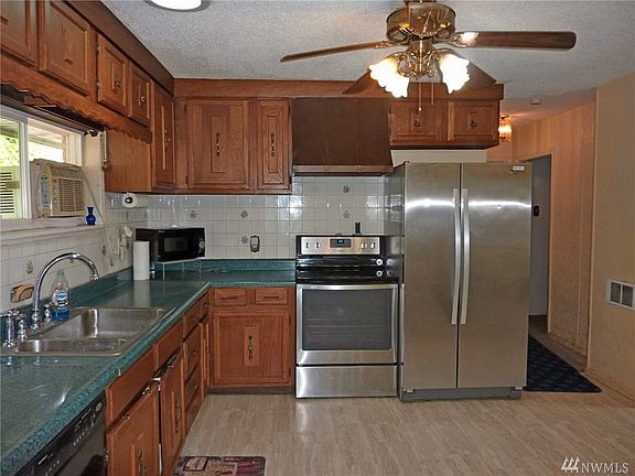 Another view of the kitchen shows the large cupboard space