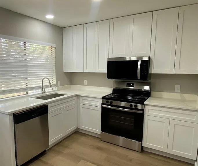 Kitchen showing New microwave, electric range and dishwasher