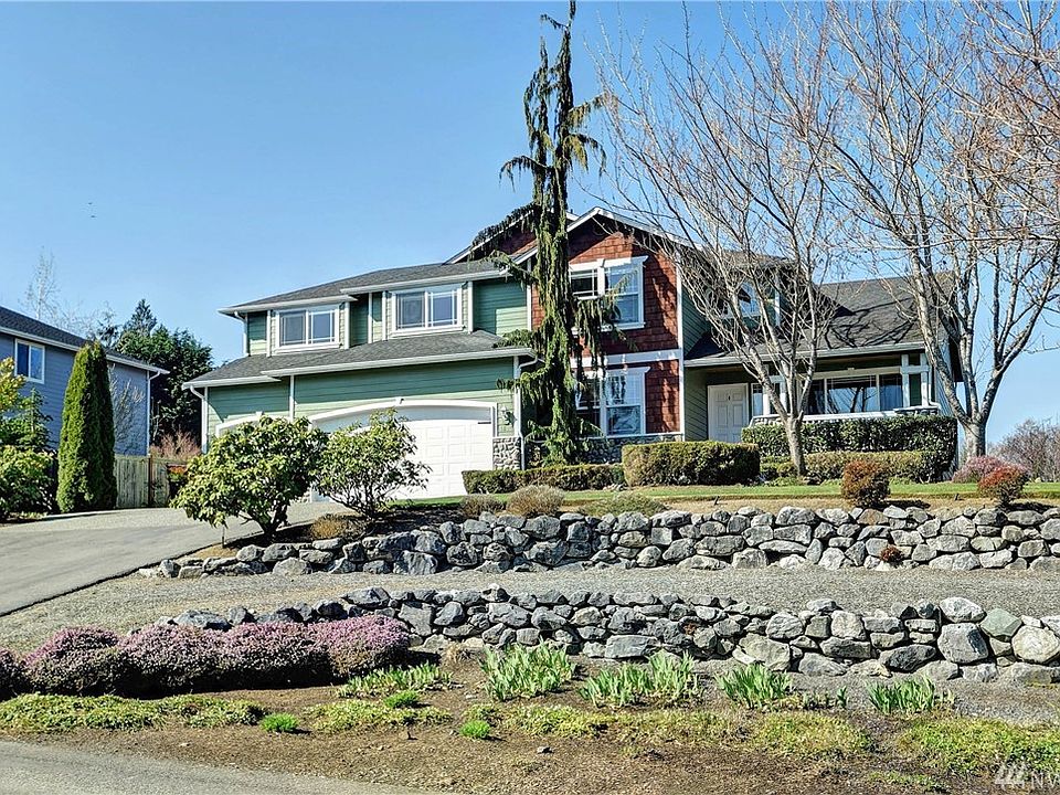 Gorgeous curb appeal with terraced drive through parking and oversized driveway.
