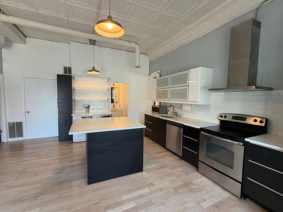 Less than 7 year old Ikea custom kitchen in black and white cabinets, Caesarstone pure white quartz counters
