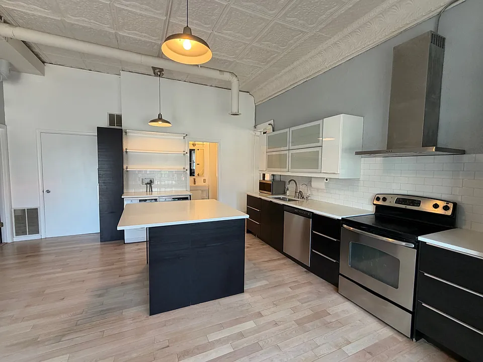 Less than 7 year old Ikea custom kitchen in black and white cabinets, Caesarstone pure white quartz counters