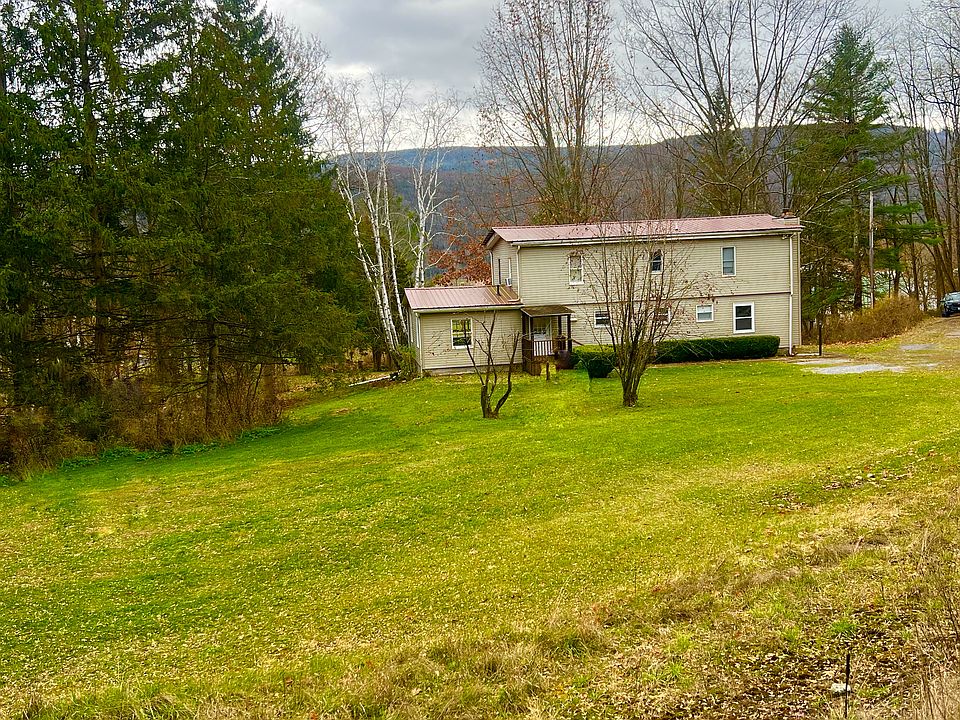 Spacious back lawn with surrounding mountain views. Enjoy the peaceful private setting and natural beauty.