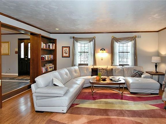 Step down from foyer to living room with built-ins and new laminate floors 2016.