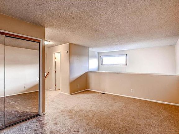 Upstairs bedroom loft. Washer/drier in mirrored closet, large closet at top of stairs, bathroom around corner.