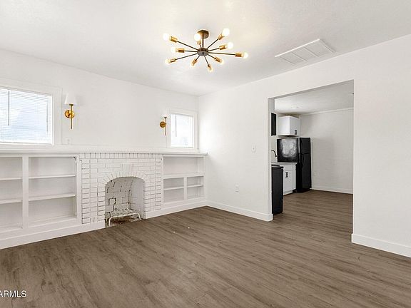 Bright, open living area with stylish LVP flooring and fireplace.
