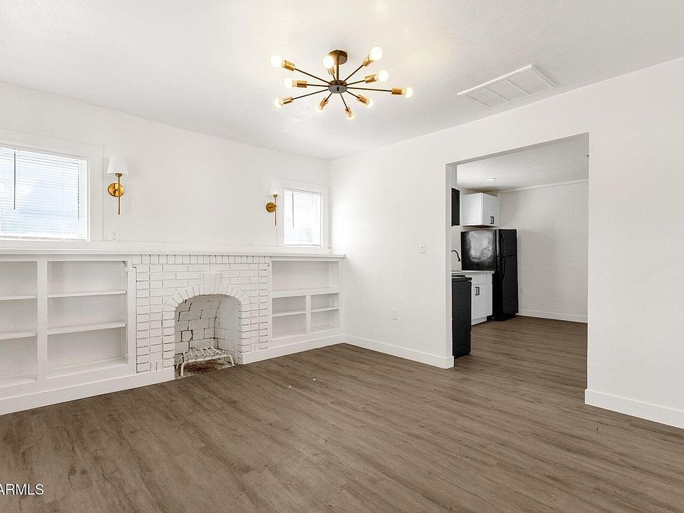 Bright, open living area with stylish LVP flooring and fireplace.