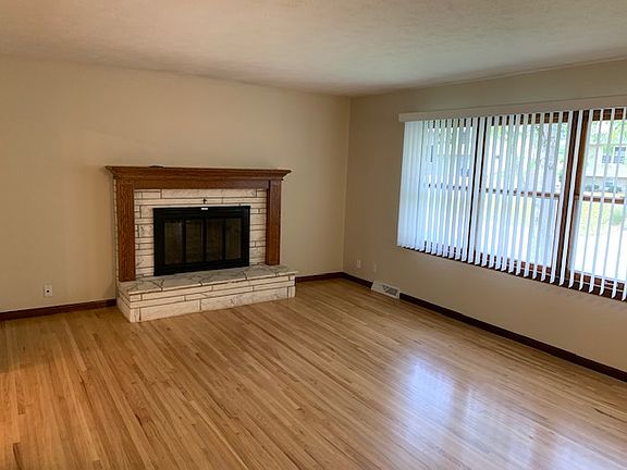 Bright, open living space with real hardwood floors and natural light, with a comfortable layout perfect for relaxing or entertaining.