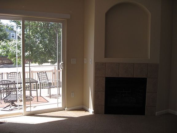 Fireplace in Living Room, sliding glass doors leading to pat