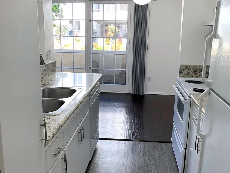 Kitchen with refrigerator, gas range stove/oven and ample cabinet space.