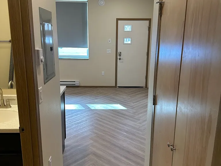 Hallway, showing living room, bathroom on left, washer/dryer on the right