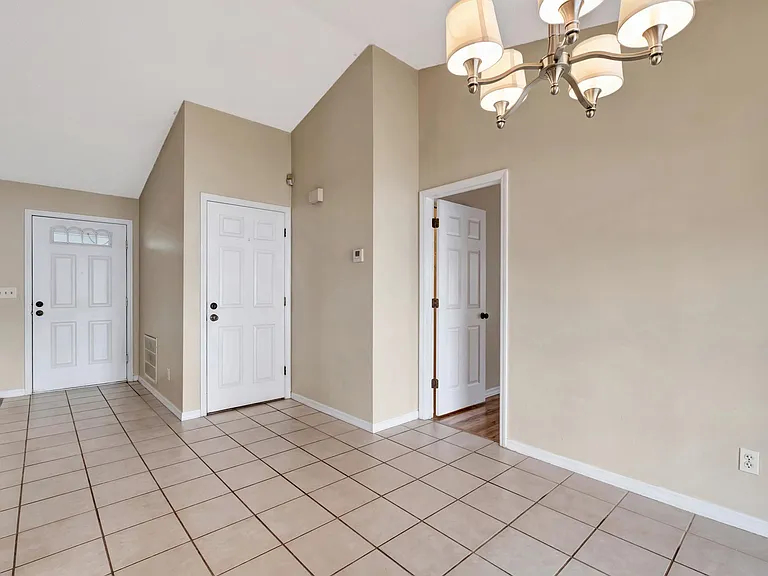 Dining Room and view of foyer along with door to garage and master bedroom