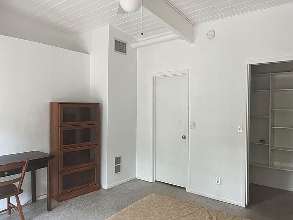 Hall entry and central A/C unit. 10 ft. ceilings, Walk-in closet with pocket door.