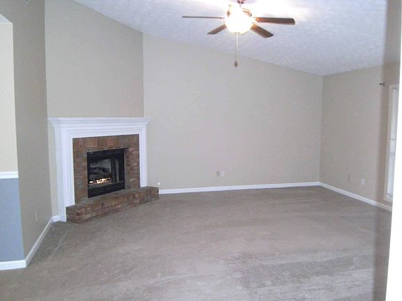 Corner Fireplace & Vaulted Ceiling in Living Room