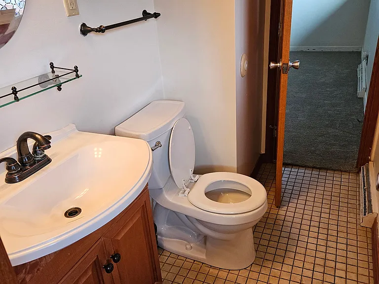half bathroom off master bathroom and access to the deck and pool