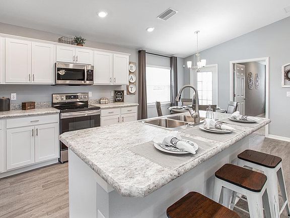 Enjoy a sunny kitchen, open to the gathering room - New home for sale in Haines City, FL. Photo show