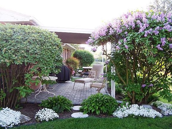 Relax on the covered porch, surrounded by beauty