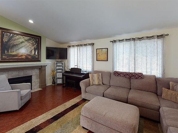 Notice NO carpet. Lots of light floods the room with all of the windows, too!