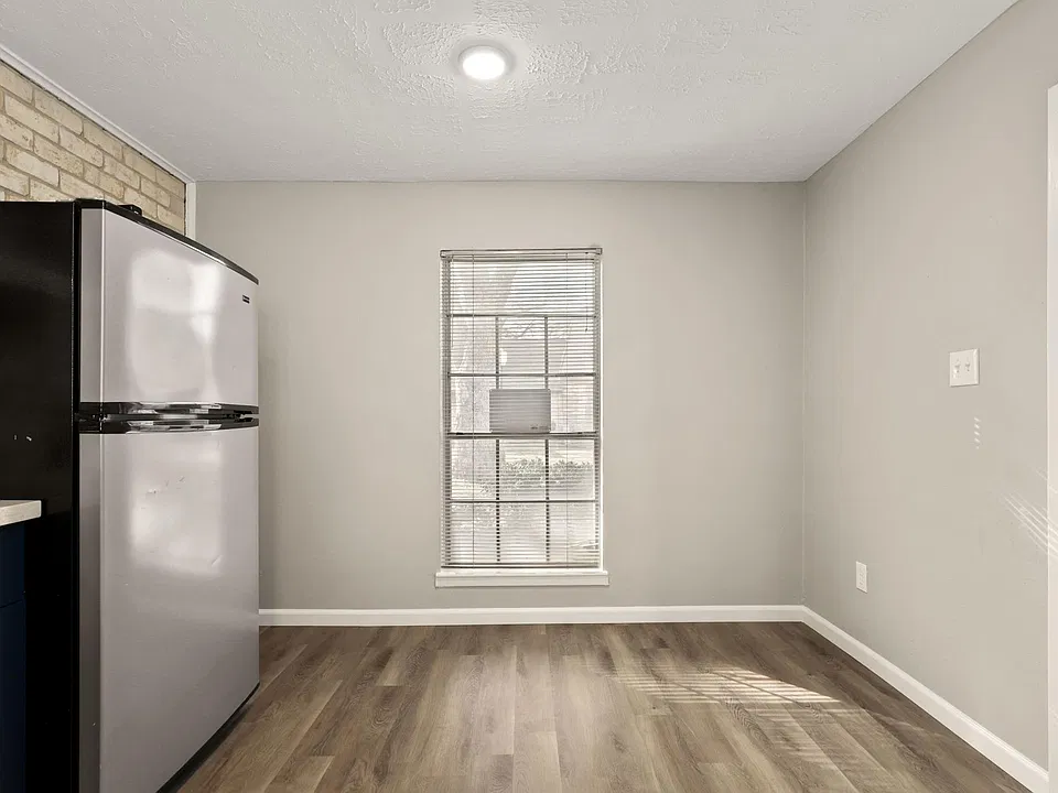 kitchen view of fridge, window, break nook