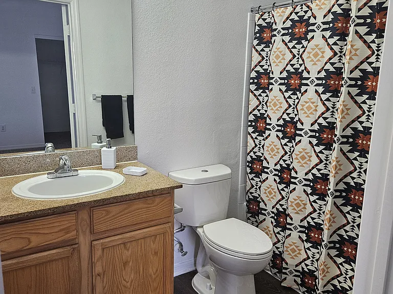 Modern and clean bathroom featuring quality fixtures, a spacious shower, and ample lighting_designed for comfort and convenience.