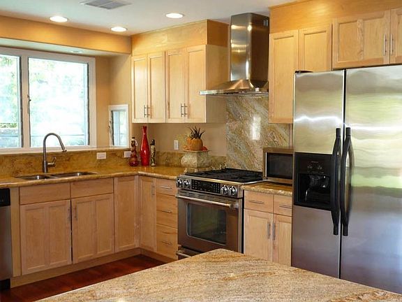 Partial view of kitchen w/maple cabinets & stainless steel appliances