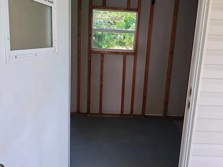 Storage room attached to garage patio