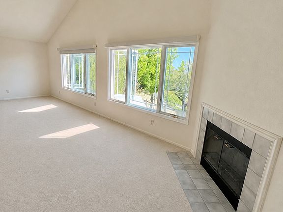 Extra large bedroom with large windows and a fireplace