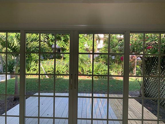 Sliding glass back door, deck freshly painted, and beautiful backyard.