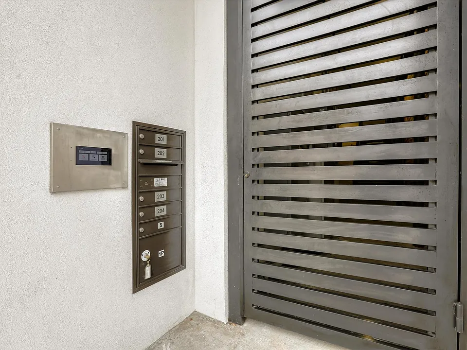 The property is secure, with gated entry for the pedestrian walkway and a private, gated parking garage for residents.