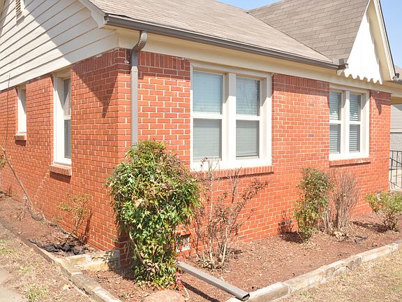 Southwest view of front of house and flower beds