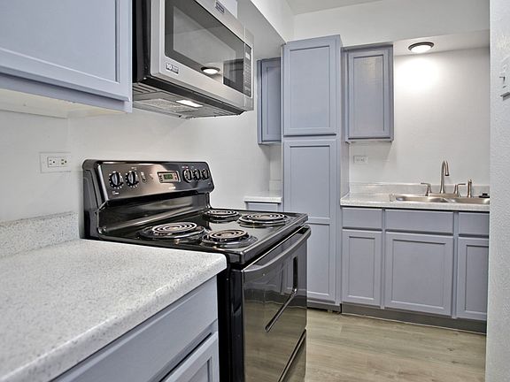 Kitchen view showing ample cabinet space and natural light
