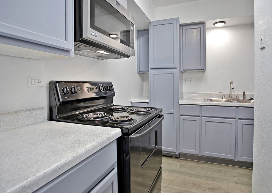Kitchen view showing ample cabinet space and natural light