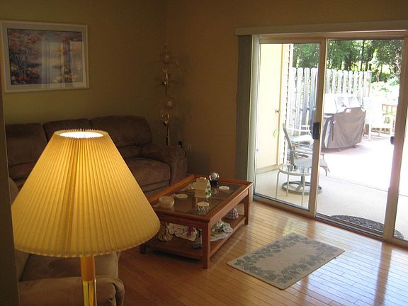 Large living room features hardwood floors and wood burning fireplace.