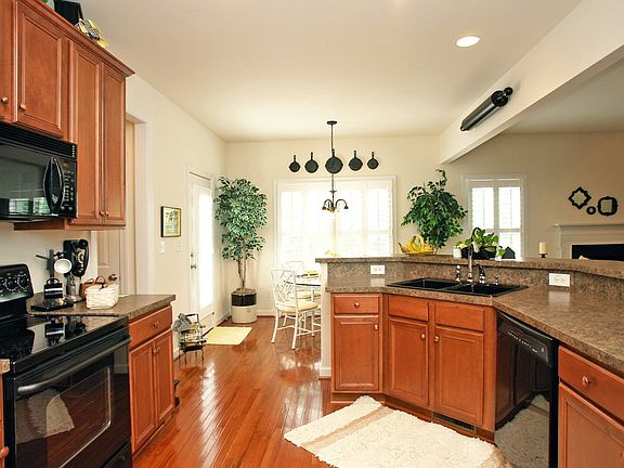 Open kitchen with hardwood floors,upgraded appliances and eat-in breakfast rm.