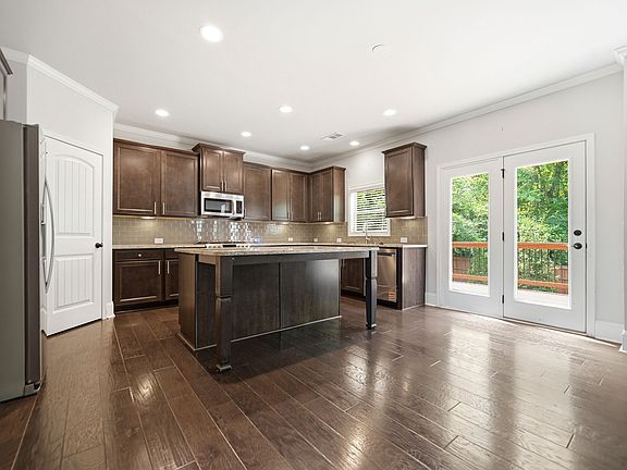 Open floor plan with large laundry on main; walk-in pantry; oversized island w/seating for 3; breakfast area; under cabinet lighting. FRIDGE WILL BE INCLUDED INCLUDED WITH APPLIANCES!