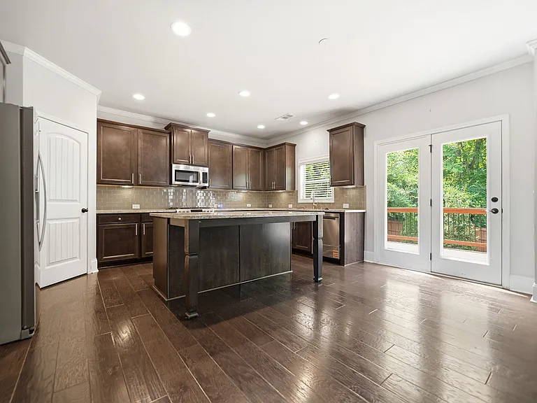 Open floor plan with large laundry on main; walk-in pantry; oversized island w/seating for 3; breakfast area; under cabinet lighting. FRIDGE WILL BE INCLUDED INCLUDED WITH APPLIANCES!