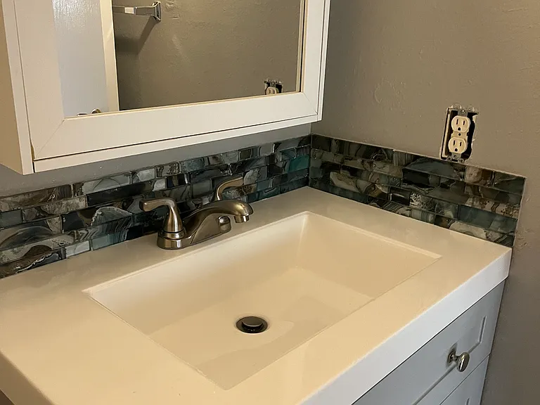 New vanity and faucet. New laminate flooring.