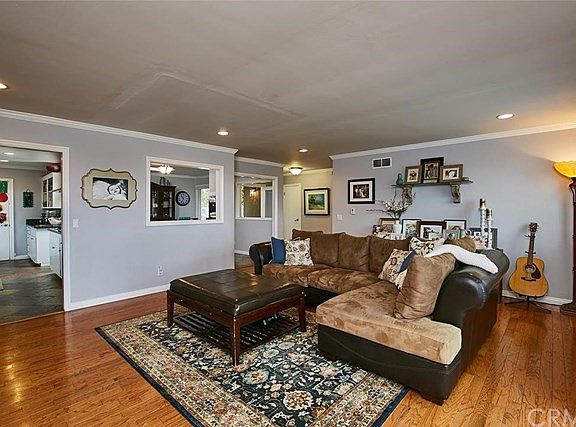 Living room as viewed from the fireplace towards the kitchen (left) and entry