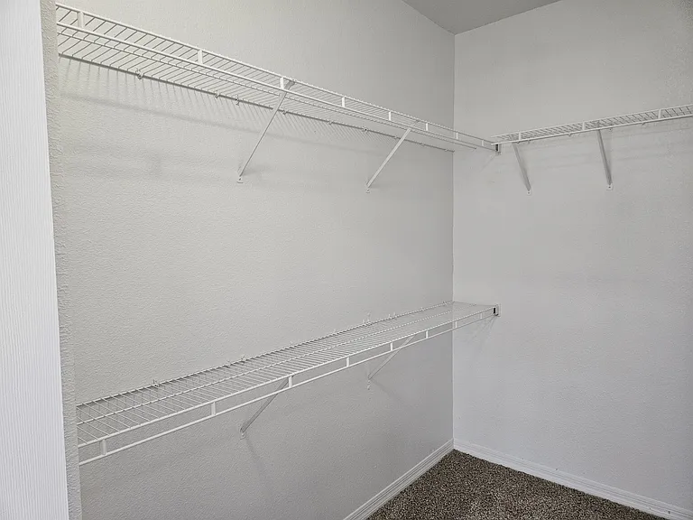 Generous walk-in closet with plenty of space for clothes, shoes, and accessories_designed for easy organization and accessibility.