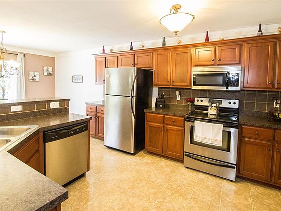 Custom maple cabinets with crown molding. Counters are an upgraded heat resistant counter top.