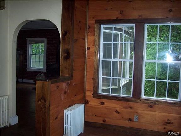 Entry through front door, arched way to living room.