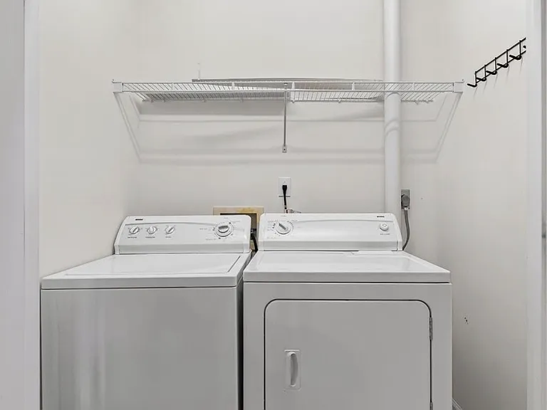 Laundry closet with washer and dryer off kitchen