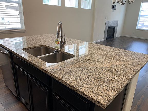 Granite Countertop, DW and sink in island, open to Family & Dining area
